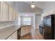 Bright kitchen with white cabinets, modern appliances, and an eat-in breakfast area at 627 New England Way, Lawrenceville, GA 30046