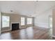 Open living room with hardwood floors, a fireplace, and natural light from the windows at 627 New England Way, Lawrenceville, GA 30046