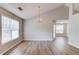 Open living space with hardwood floors, vaulted ceilings, and natural lighting at 627 New England Way, Lawrenceville, GA 30046