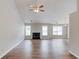 Open living room with a fireplace, hardwood floors, and large windows for ample natural light at 627 New England Way, Lawrenceville, GA 30046