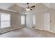 Spacious main bedroom featuring a tray ceiling, ceiling fan, and two bright windows at 627 New England Way, Lawrenceville, GA 30046