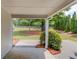 Covered patio overlooking a spacious, tree-lined backyard at 627 New England Way, Lawrenceville, GA 30046