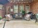 Covered back patio with comfortable seating and grill at 1466 Lake Forest Ln, Mcdonough, GA 30253