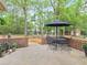 Back patio with outdoor seating area and surrounding greenery at 1466 Lake Forest Ln, Mcdonough, GA 30253