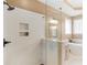 This bathroom offers a glass enclosed shower with a tiled nook, a soaking tub, modern finishes and a granite countertop at 1466 Lake Forest Ln, Mcdonough, GA 30253