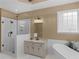 This bathroom features a glass enclosed shower with subway tiles, and a soaking tub by a bright window for spa days at 1466 Lake Forest Ln, Mcdonough, GA 30253