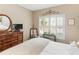 This bedroom has a four poster bed, a dresser, a window with shutters and a mirror for getting ready at 1466 Lake Forest Ln, Mcdonough, GA 30253