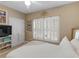 Bright bedroom with shutters, a dresser and a view of a bed with white linens at 1466 Lake Forest Ln, Mcdonough, GA 30253