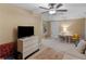 Bonus room with sofa, dresser, large TV and a desk area at 1466 Lake Forest Ln, Mcdonough, GA 30253