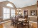 Elegant dining room featuring hardwood floors, wainscoting, large windows and chandelier at 1466 Lake Forest Ln, Mcdonough, GA 30253