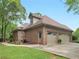Exterior side view of the home and attached garages at 1466 Lake Forest Ln, Mcdonough, GA 30253
