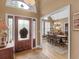Inviting foyer with hardwood floors, a decorative front door, and views into dining room at 1466 Lake Forest Ln, Mcdonough, GA 30253