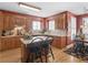 Charming kitchen with custom wood cabinets, an island with breakfast bar, and views into dining area at 1466 Lake Forest Ln, Mcdonough, GA 30253
