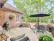 Inviting brick patio with outdoor seating, grill, and string lights, perfect for entertaining at 1466 Lake Forest Ln, Mcdonough, GA 30253