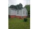 Exterior of the home featuring white siding with red painted foundation and green lawn at 4253 Hanes Dr, Decatur, GA 30035