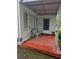 Cozy covered porch with painted wood flooring and exterior door at 4253 Hanes Dr, Decatur, GA 30035