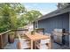 Outdoor living space with grill, wood table and comfortable seating at 4448 Denise Dr, Decatur, GA 30035