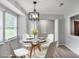 Bright dining area features a round table, modern lighting, and natural light from a large window at 4448 Denise Dr, Decatur, GA 30035