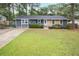 Charming home boasts a well-manicured lawn, stone accents, and a welcoming front entrance at 4448 Denise Dr, Decatur, GA 30035