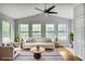 Bright living room featuring a comfortable sofa, stylish rug, and large windows for natural light at 4448 Denise Dr, Decatur, GA 30035