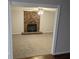 Cozy living room features a brick fireplace, neutral carpeting, and a ceiling fan, creating a relaxing atmosphere at 4448 Denise Dr, Decatur, GA 30035