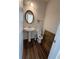Half bathroom featuring a pedestal sink, oval mirror and hardwood floors at 6474 Grey Fox Way, Riverdale, GA 30296