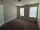 Bedroom featuring carpet and two windows at 6474 Grey Fox Way, Riverdale, GA 30296