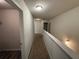 A neutral-toned hallway with carpet, a white railing, and recessed lighting at 6474 Grey Fox Way, Riverdale, GA 30296