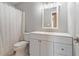 Clean bathroom featuring a modern vanity, updated fixtures, and a shower/tub combo with a shower curtain at 6895 Old Fox Trl, Stone Mountain, GA 30087