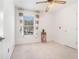 Cozy bedroom with carpet flooring, a window overlooking the neighborhood, and neutral wall paint at 6895 Old Fox Trl, Stone Mountain, GA 30087