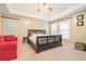Spacious bedroom featuring a tray ceiling, carpet floors, and a decorative sleigh bed at 6895 Old Fox Trl, Stone Mountain, GA 30087