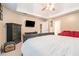 This bedroom boasts modern decor, tv, ceiling fan, and a comfortable red loveseat at 6895 Old Fox Trl, Stone Mountain, GA 30087