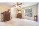 Bright bedroom with a ceiling fan, neutral paint, carpet, and large windows providing lots of natural light at 6895 Old Fox Trl, Stone Mountain, GA 30087