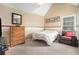 Comfortable bedroom with a bed, chair, dresser, and ample natural light from the window at 6895 Old Fox Trl, Stone Mountain, GA 30087