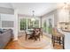 Bright dining area with hardwood floors, round table, stylish light fixture, and lots of natural light at 6895 Old Fox Trl, Stone Mountain, GA 30087