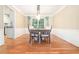 Elegant dining room featuring hardwood floors, large windows, and stylish lighting fixture at 6895 Old Fox Trl, Stone Mountain, GA 30087