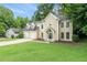 Charming two-story home with a two-car garage, well-manicured lawn, and mature trees at 6895 Old Fox Trl, Stone Mountain, GA 30087
