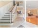 Inviting foyer featuring tile flooring, staircase, and open view to dining area at 6895 Old Fox Trl, Stone Mountain, GA 30087