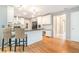 Modern kitchen featuring an island with seating, hardwood floors, and white cabinetry at 6895 Old Fox Trl, Stone Mountain, GA 30087