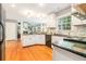 Well-appointed kitchen featuring granite countertops, stainless steel appliances, and hardwood floors at 6895 Old Fox Trl, Stone Mountain, GA 30087