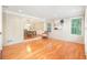 Bright living room featuring hardwood floors, large windows, and an open layout to the dining area at 6895 Old Fox Trl, Stone Mountain, GA 30087