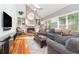 Spacious living room featuring vaulted ceilings, a brick fireplace, built-in shelves, and large windows at 6895 Old Fox Trl, Stone Mountain, GA 30087