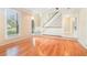 Bright living room featuring hardwood floors, large windows, and open layout to the foyer at 6895 Old Fox Trl, Stone Mountain, GA 30087