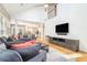 Contemporary living room featuring hardwood floors, modern furniture, and seamless access to the kitchen at 6895 Old Fox Trl, Stone Mountain, GA 30087