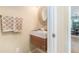 Elegant powder room featuring a floating vanity with a modern sink, decorative mirror, and stylish fixtures at 6895 Old Fox Trl, Stone Mountain, GA 30087