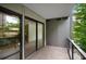 Outdoor patio with city view through floor-to-ceiling windows and glass balcony railing at 867 Peachtree Ne St # 202, Atlanta, GA 30308
