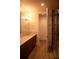 Modern bathroom featuring dual sinks, a large mirror, and a walk-in shower at 867 Peachtree Ne St # 202, Atlanta, GA 30308
