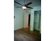 Bedroom showcasing an organized closet, smooth wood flooring, a modern ceiling fan, and a neutral color palette at 867 Peachtree Ne St # 202, Atlanta, GA 30308
