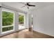 This bedroom features large windows, hardwood floors, and modern ceiling fan at 867 Peachtree Ne St # 202, Atlanta, GA 30308