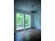 Bright bedroom with large windows showcasing the outdoor greenery and a ceiling fan at 867 Peachtree Ne St # 202, Atlanta, GA 30308